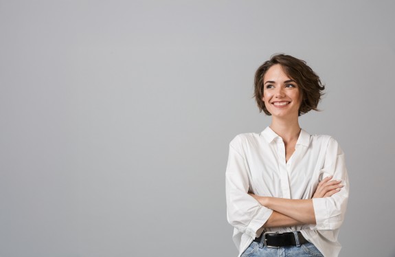 Frau mit kurzen Haaren lächelt selbstbewusst